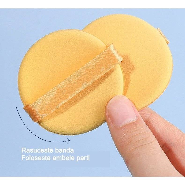Bureți de machiaj galbeni cu bandă ajustabilă, utilizabili pe ambele părți. Design practic pentru o aplicare eficientă.